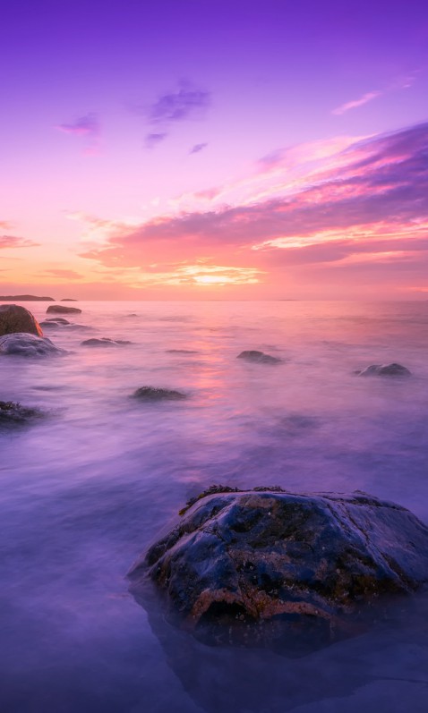 Plaża, głazy, ocean i zachód słońca